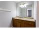 Bathroom vanity with granite countertops, dark wood cabinetry, and large mirror at 3485 Sheree Trl, Stone Mountain, GA 30087