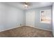 Bedroom featuring neutral walls, plush carpet, and a window for natural light at 3485 Sheree Trl, Stone Mountain, GA 30087