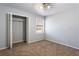 Bedroom featuring neutral walls, plush carpet, and an open closet for storage at 3485 Sheree Trl, Stone Mountain, GA 30087