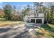 View of the home's exterior showing the two-car garage and mature trees surrounding the property at 3485 Sheree Trl, Stone Mountain, GA 30087