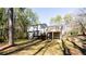 Back exterior of the house with a wooden deck and a large backyard at 3485 Sheree Trl, Stone Mountain, GA 30087