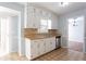 Bright kitchen with stainless appliances, double sinks, and light wooden countertops at 3485 Sheree Trl, Stone Mountain, GA 30087