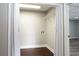 This is a laundry room with a wood floor, overhead light, and bi-fold doors at 3485 Sheree Trl, Stone Mountain, GA 30087