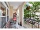View of a cozy balcony with outdoor furniture and decorative items with view of the neighborhood landscaping at 955 Juniper Ne St # 4125, Atlanta, GA 30309