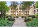 View of a peaceful courtyard surrounded by lush landscaping and the building's red tile roof at 955 Juniper Ne St # 4125, Atlanta, GA 30309