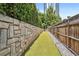 Outdoor dog run with artificial turf and stone wall, ideal for pet owners at 955 Juniper Ne St # 4125, Atlanta, GA 30309