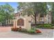 Exterior view of the Tuscany Condominiums entrance with a sign, landscaping, and the building in the background at 955 Juniper Ne St # 4125, Atlanta, GA 30309