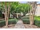Manicured landscaping and walkway leading to a building entrance with trees and bushes surrounding at 955 Juniper Ne St # 4125, Atlanta, GA 30309