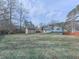 Large backyard featuring a storage shed, privacy fence, mature trees, and green grass at 1036 Pinetree Ct, Powder Springs, GA 30127