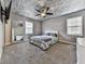 Cozy bedroom featuring soft carpeting, a comfortable bed, and natural light from two windows at 1036 Pinetree Ct, Powder Springs, GA 30127