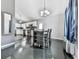 Bright dining area featuring sleek black floors, a modern chandelier, and comfortable seating at 1036 Pinetree Ct, Powder Springs, GA 30127