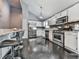 Modern kitchen featuring stainless steel appliances, white cabinets, and sleek black flooring at 1036 Pinetree Ct, Powder Springs, GA 30127