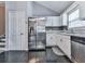 Contemporary kitchen boasting stainless steel appliances, white cabinetry, and black hardwood floors at 1036 Pinetree Ct, Powder Springs, GA 30127