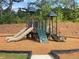 Community playground featuring a slide, climbing wall, and safety mulch for a fun and safe play area at 176 Silverton Dr, Dacula, GA 30019