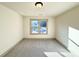 Cozy bedroom featuring a large window, neutral walls, and plush carpeting at 254 Lotus Ln, Covington, GA 30016