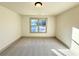 Cozy bedroom with plush gray carpeting, neutral paint, and a window for natural light at 254 Lotus Ln, Covington, GA 30016