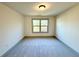 Comfortable bedroom featuring a large window, neutral walls, and plush carpeting at 254 Lotus Ln, Covington, GA 30016