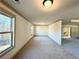 Expansive bedroom featuring neutral carpeting, trim and multiple windows for ample natural light at 254 Lotus Ln, Covington, GA 30016