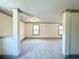 Spacious bonus room featuring neutral carpet, paint, and gray trim with natural light from windows at 254 Lotus Ln, Covington, GA 30016