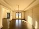 Dining room with hardwood floors, coffered ceilings, decorative molding, and a chandelier, with great light at 254 Lotus Ln, Covington, GA 30016