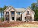 New two-story brick home featuring large windows and classic architectural details, currently under construction at 254 Lotus Ln, Covington, GA 30016