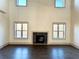 Living room features dark hardwood floors and fireplace with square tiles and natural light from the windows at 254 Lotus Ln, Covington, GA 30016