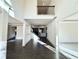 Bright foyer with dark hardwood floors, a high ceiling, and wrought iron staircase at 254 Lotus Ln, Covington, GA 30016