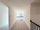 Bright hallway with plush carpeting and a view of a decorative window at 254 Lotus Ln, Covington, GA 30016