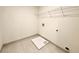 The well-lit laundry room features a tile floor, utility sink, and wire shelving at 254 Lotus Ln, Covington, GA 30016