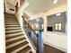 Staircase featuring hardwood steps, black metal railings, and views into the home's living areas at 254 Lotus Ln, Covington, GA 30016