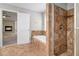 Bathroom featuring a bathtub and a glass-enclosed shower with brown tiling at 2725 Palmview Sw Ct, Atlanta, GA 30331