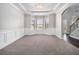 Formal dining room with wainscoting, tray ceiling, and a view of the staircase at 2725 Palmview Sw Ct, Atlanta, GA 30331