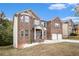 Two-story brick home featuring a two-car garage, a manicured lawn, and mature trees at 2725 Palmview Sw Ct, Atlanta, GA 30331