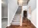 Grand foyer with staircase, wood and carpet flooring, and views into the living spaces at 2725 Palmview Sw Ct, Atlanta, GA 30331