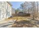 Backyard view with patio, grass, fence and a wooded perimeter at 3127 Leyland Ct, Decatur, GA 30034