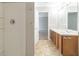 Bright bathroom featuring double sinks with wooden cabinets and a tiled shower stall at 3127 Leyland Ct, Decatur, GA 30034