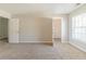 Spacious carpeted bedroom featuring a bright window, closet and neutral walls at 3127 Leyland Ct, Decatur, GA 30034