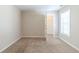 Bedroom with neutral walls, carpet, and a window letting in natural light at 3127 Leyland Ct, Decatur, GA 30034