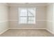 Cozy bedroom with neutral walls, carpet flooring, and a bright window at 3127 Leyland Ct, Decatur, GA 30034