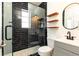 Modern bathroom with a glass-enclosed shower featuring black marble tiling and a sleek vanity with a round mirror at 589 Auburn Ne Ave # F, Atlanta, GA 30312