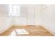 Bright, empty room with wood floor, window with shutters, white walls, and trim, creating a blank canvas at 589 Auburn Ne Ave # F, Atlanta, GA 30312