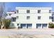 Apartment building featuring three levels, flat roof, and garage doors at 589 Auburn Ne Ave # F, Atlanta, GA 30312