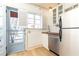 Efficient kitchen with stainless steel appliances, butcher block countertop, white cabinets and door to the outside at 589 Auburn Ne Ave # F, Atlanta, GA 30312