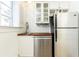 Well-lit kitchen with stainless steel appliances, butcher block countertop, and white cabinets, offering a functional space at 589 Auburn Ne Ave # F, Atlanta, GA 30312