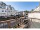 View from wood back deck of townhome exteriors and street, with covered furniture and plant pots at 852 Constellation Dr, Decatur, GA 30033