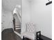 An entryway with a tufted chair, hardwood floors, and stairs to the second level at 852 Constellation Dr, Decatur, GA 30033