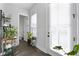 Hallway with plants in a natural light filled area that leads to a bathroom and outdoor access at 852 Constellation Dr, Decatur, GA 30033