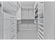 Walk-in closet with white shelving on either side and open space for storage at 207 Cole Ne St, Marietta, GA 30060