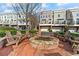 Community firepit area with brick surround and wooden chairs, perfect for outdoor gatherings at 207 Cole Ne St, Marietta, GA 30060