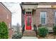 Charming brick home featuring a vibrant red front door adorned with an American flag for a welcoming entrance at 207 Cole Ne St, Marietta, GA 30060